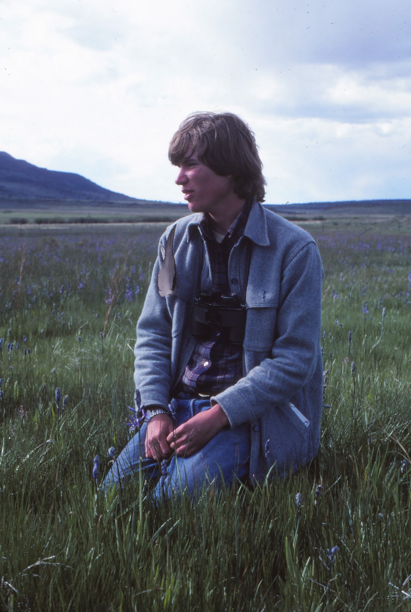 A photo of Chris with binoculars in the field in 1982
